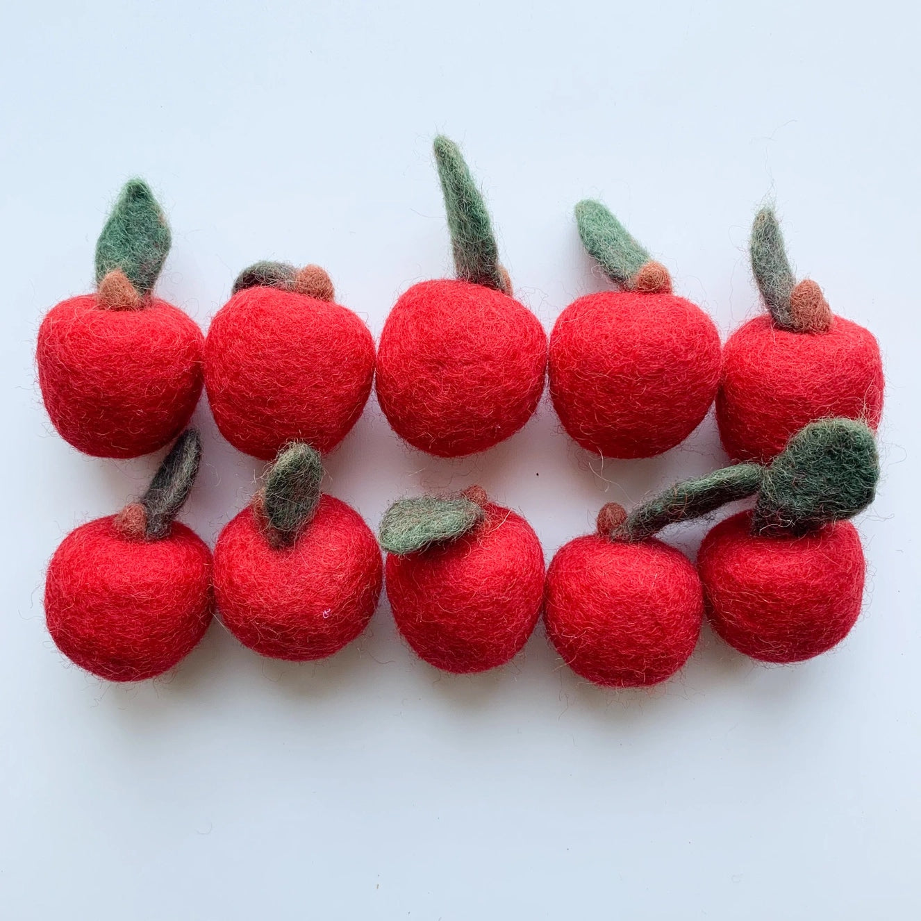 set of mini red felt apples