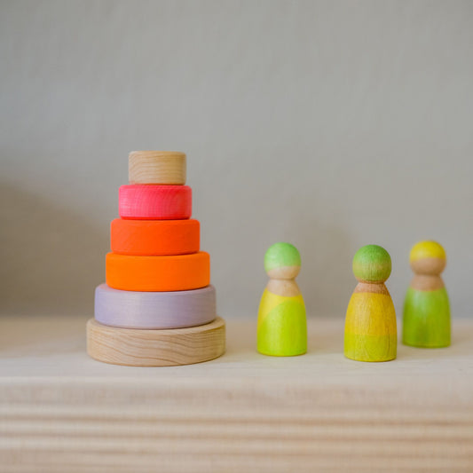 Neon pink conical stacking tower with neon green wooden people