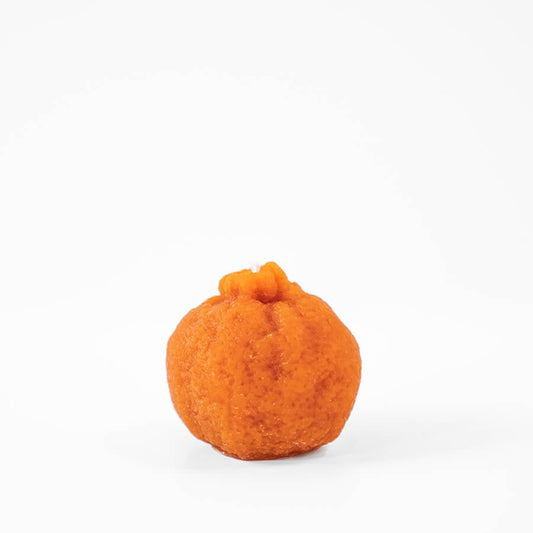 Orange felt pumpkin on a white background