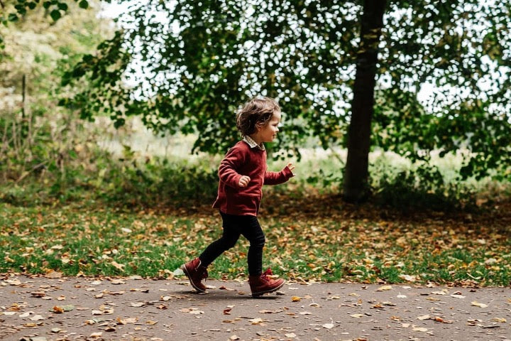 child walking outside wearing organic ribbed brick raglan