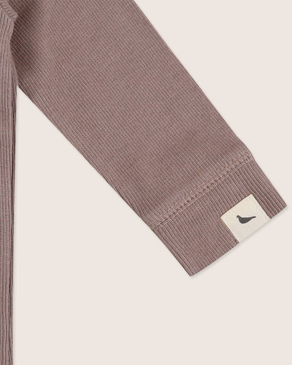 sleeve detail for ribbed long-sleeve onesie in stone