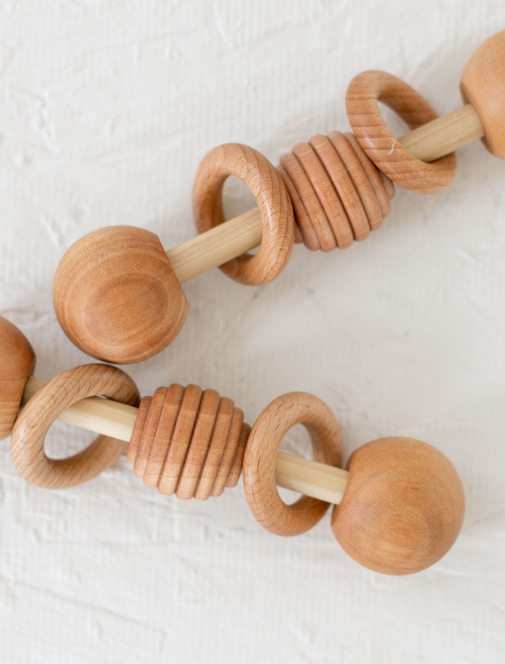 Wooden baby teething ring on a white background