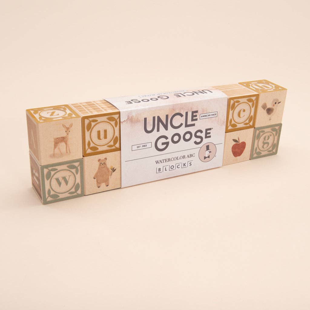 Box of Uncle Goose watercolor ABC blocks on a beige background