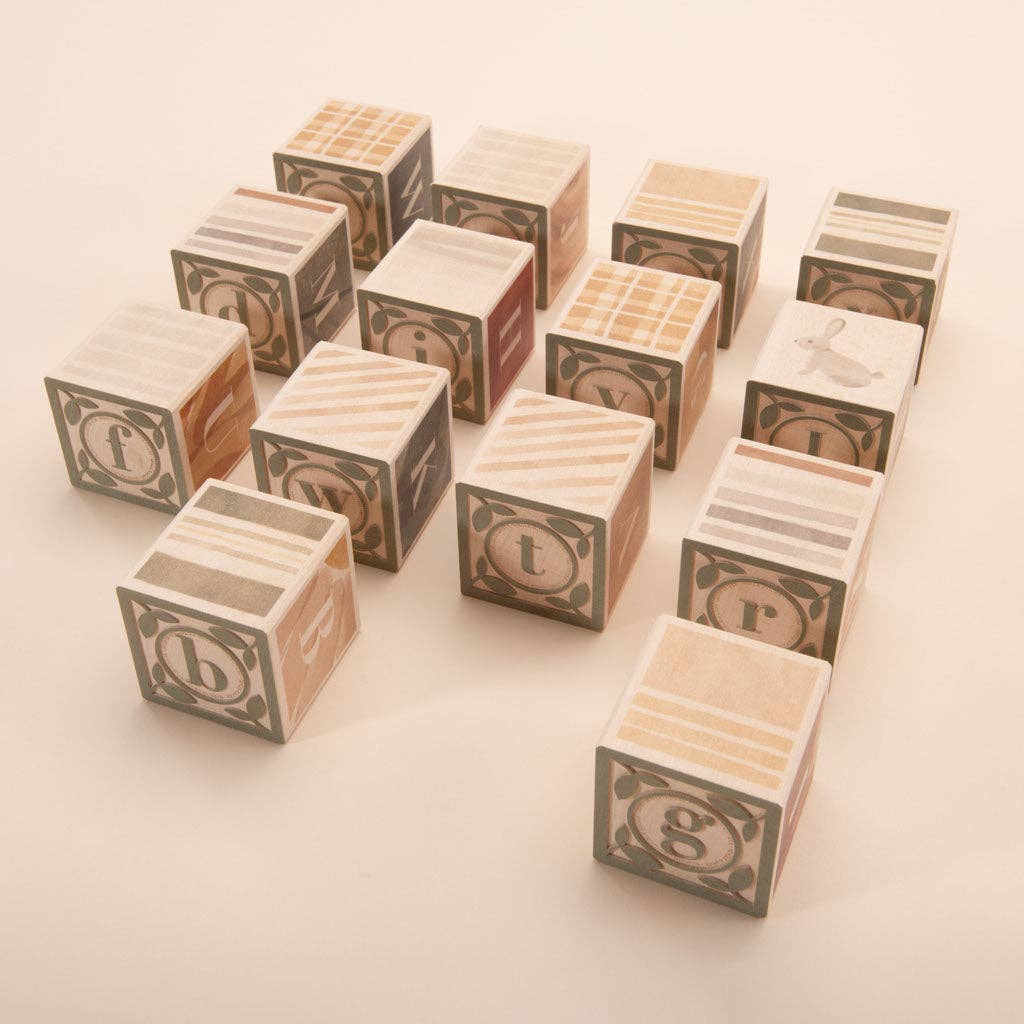 Set of wooden blocks with letter designs on a light background
