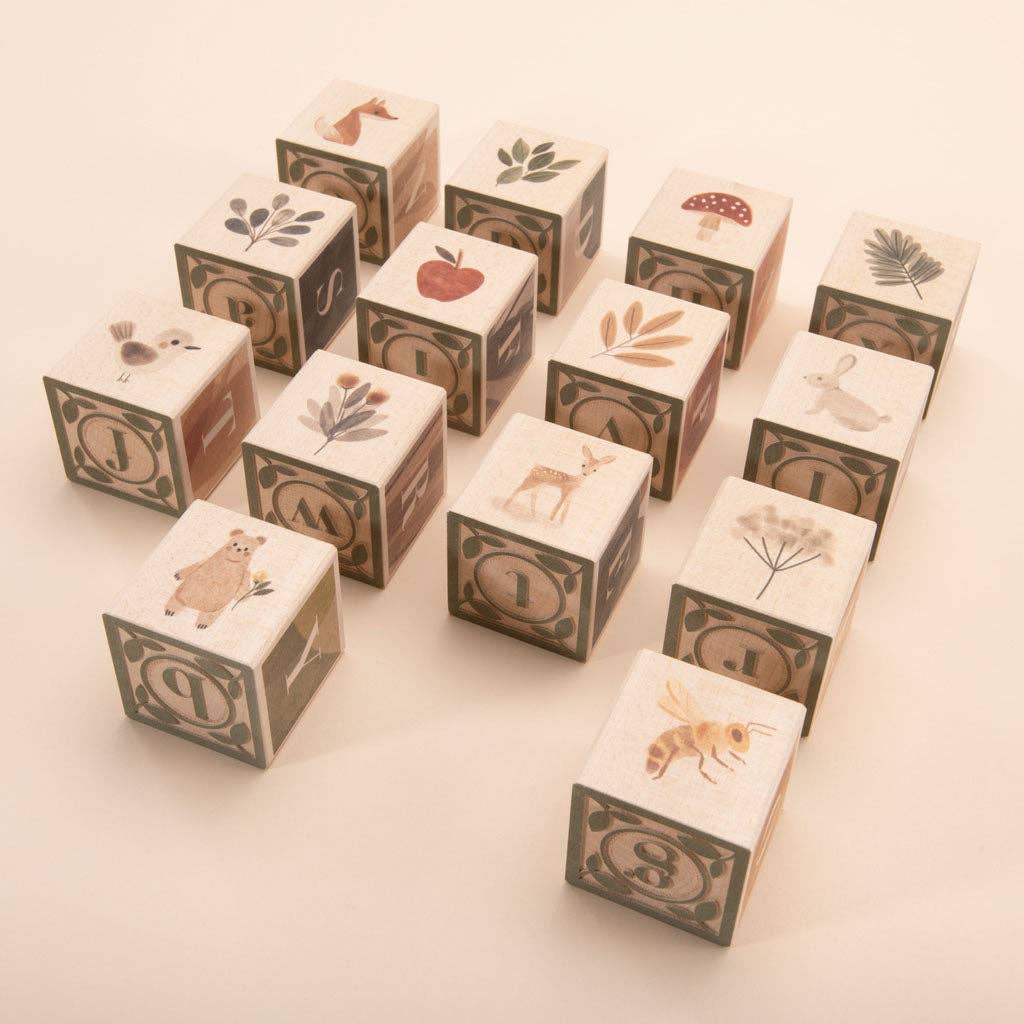 Set of wooden blocks with animal and nature illustrations on a light background