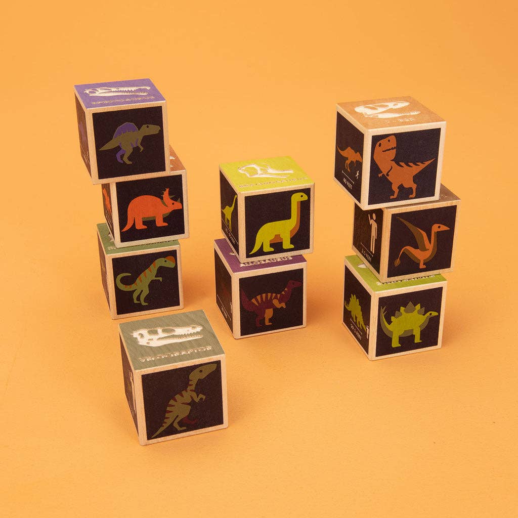 Stack of dinosaur-themed children's blocks on an orange background