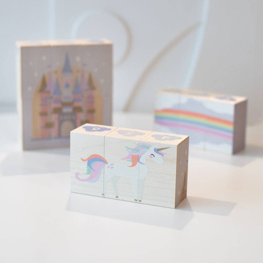 Three wooden blocks with colorful designs on a white surface