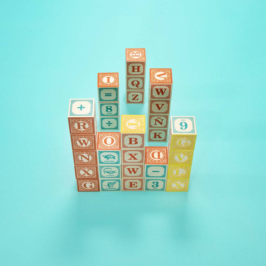 Stack of colorful alphabet and number blocks on a light blue background