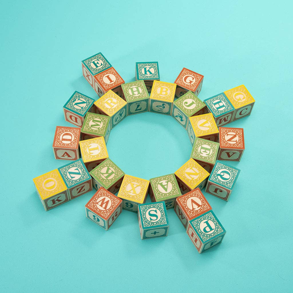 Colorful alphabet blocks arranged in a circular pattern on a blue background