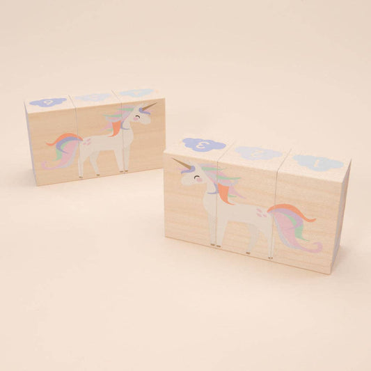 Set of wooden blocks with unicorn designs on a beige background