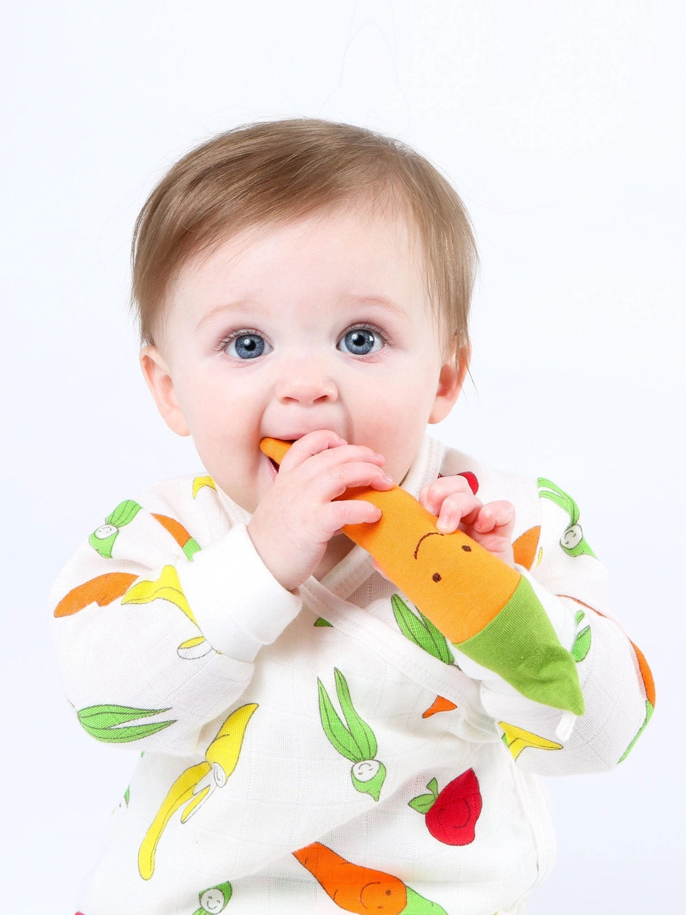 baby chewing on organic plush carrot teether