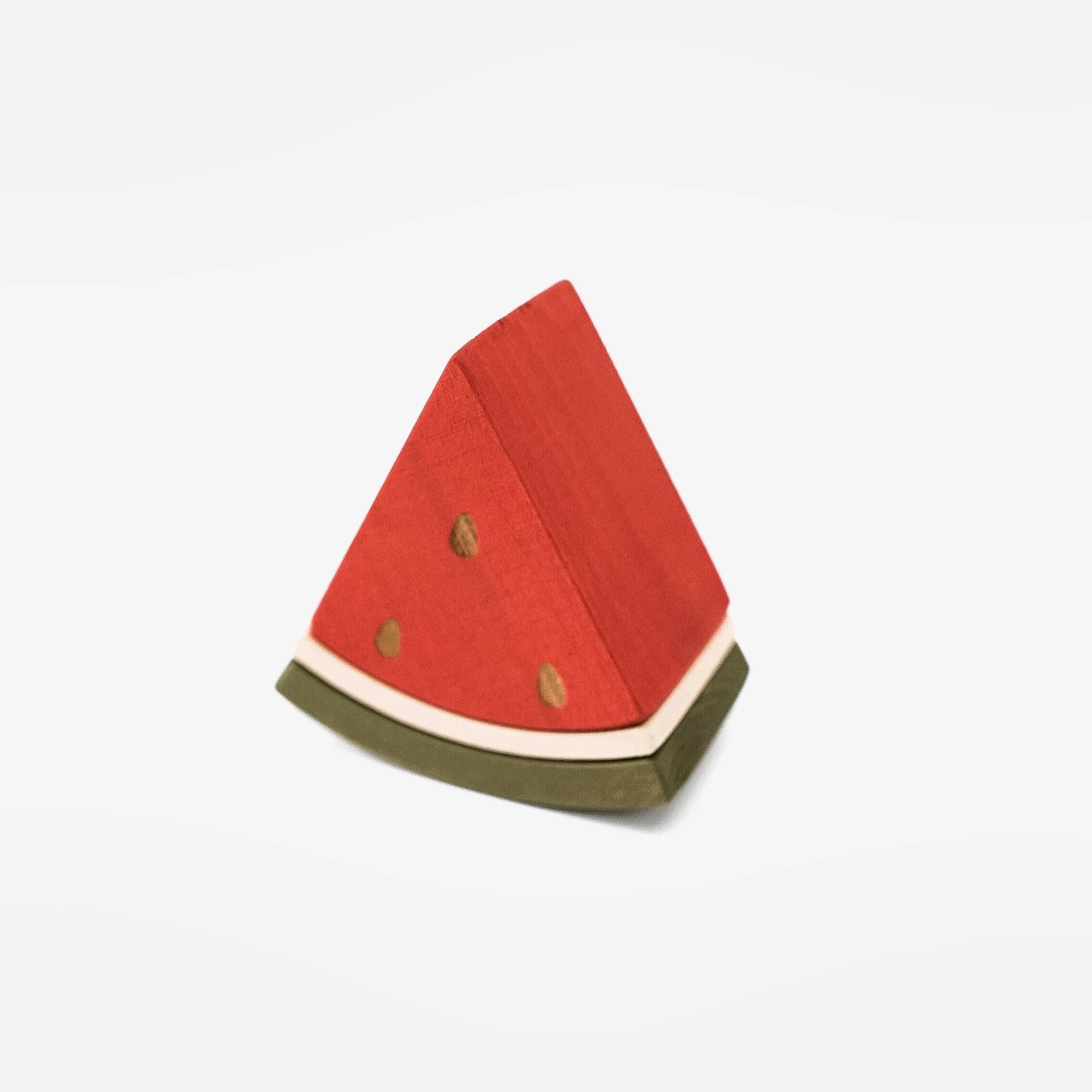 a wooden triangle piece of watermelon on a white back ground