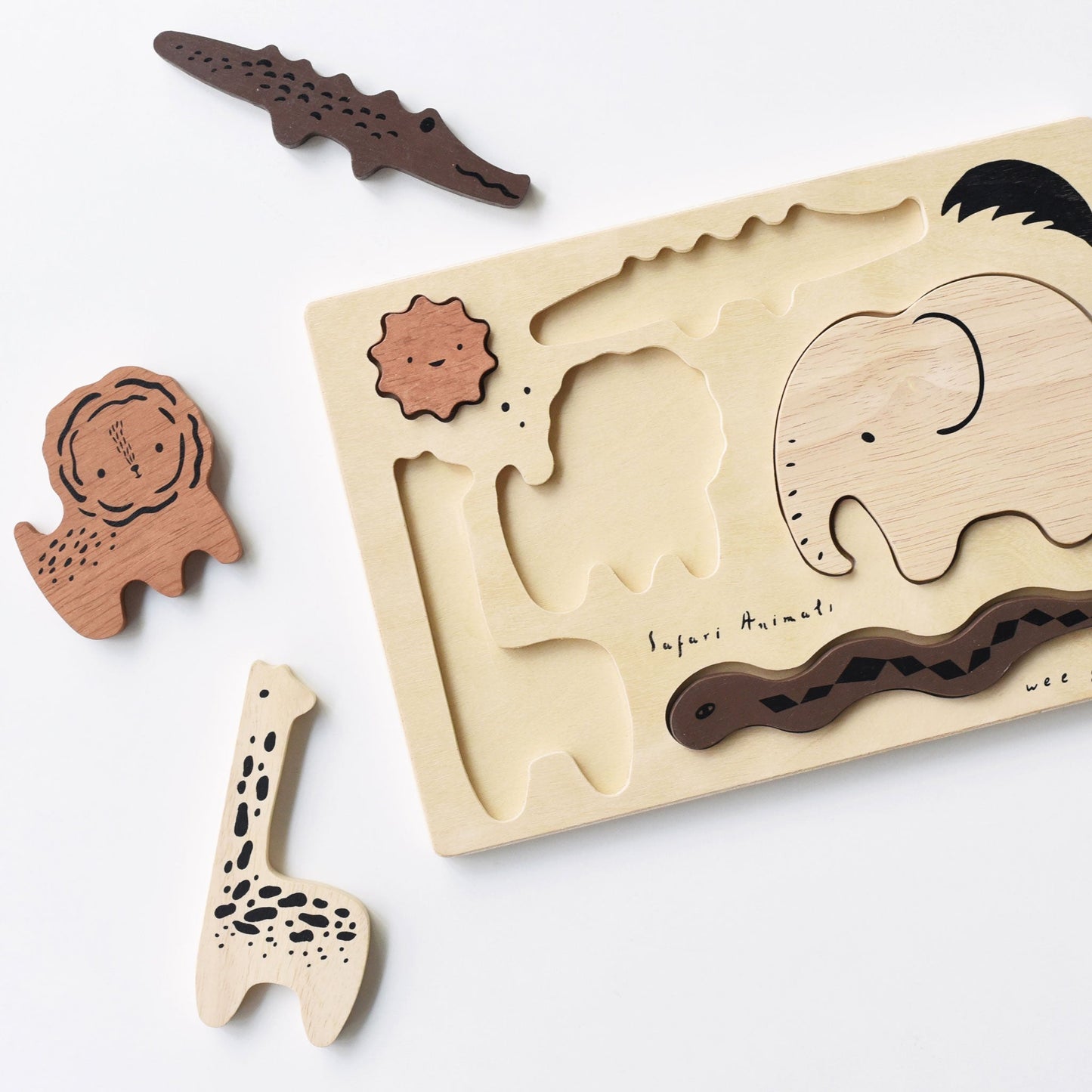 Wooden puzzle with animal shapes on a white background