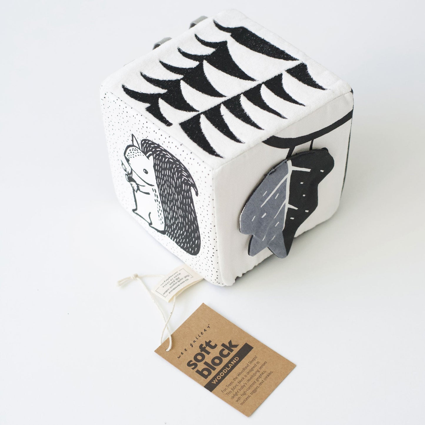 Cube-shaped soft book with black and white patterns on a white background