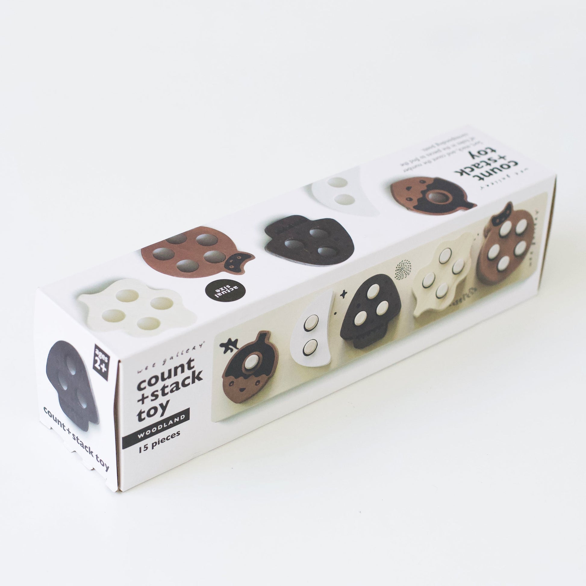 Box of a 'count + stack toy' with wooden shapes on a white background