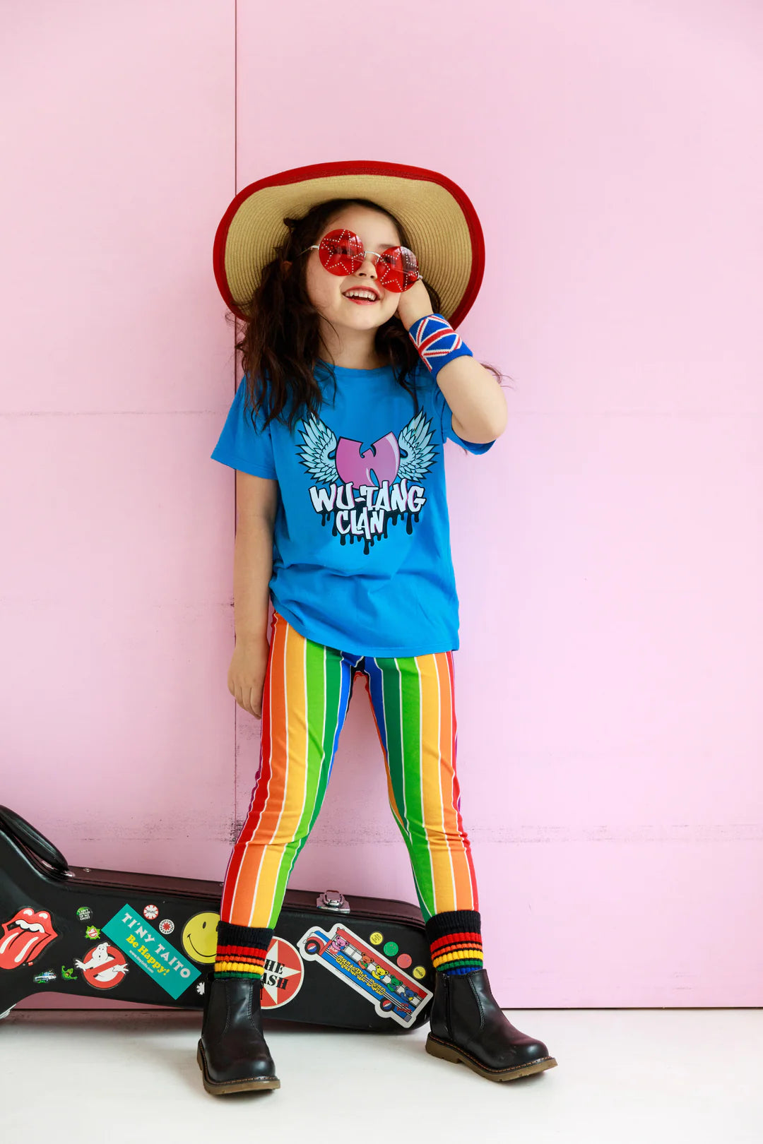 Child wearing a star hat, red sunglasses, rainbow striped pants and blue Wu-Tang Clan organic short sleeve tee