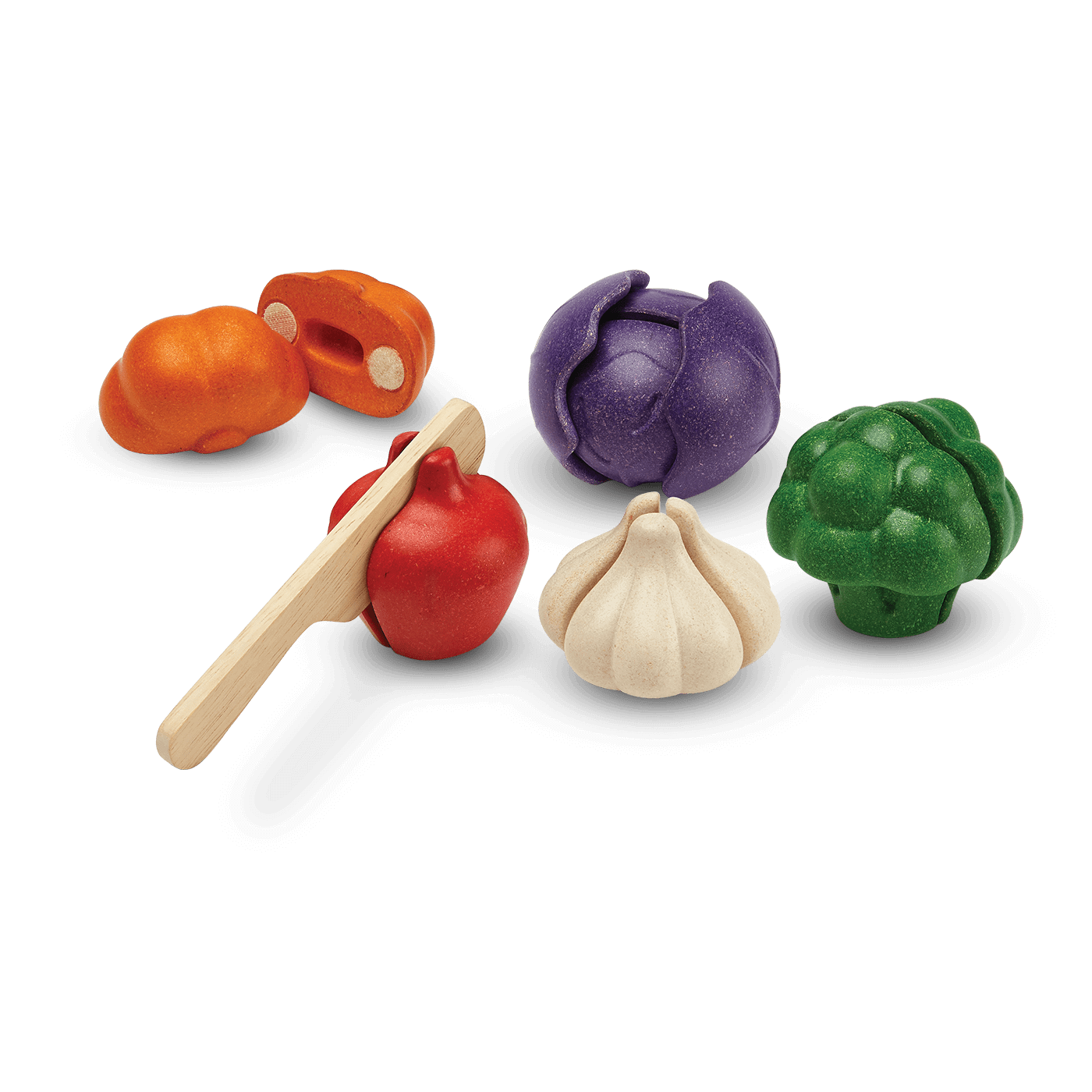 A wooden vegetable set, including garlic, broccoli, onion, pumpkin, and tomato. The tomato is being cut