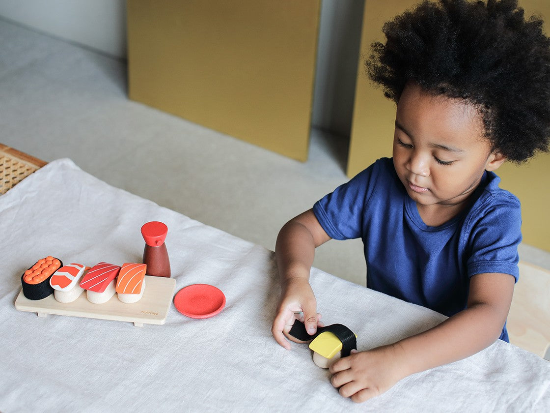 Child playing with Sushi Set Plan Toys