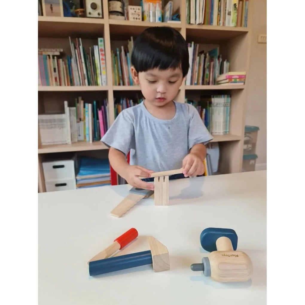 Child with Handy Carpenter Set by Plan Toys