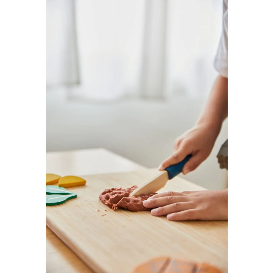 Child playing with chef set by PlanToys