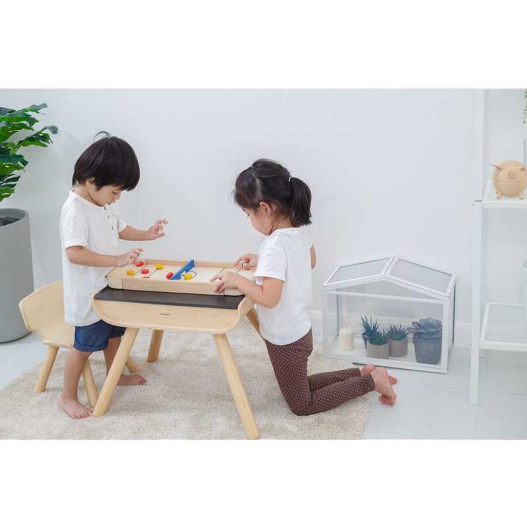 Kids playing Shuffleboard-Game by Plan Toys