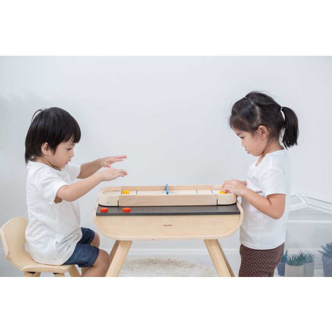 kids playing Shuffleboard-Game by Plan Toys