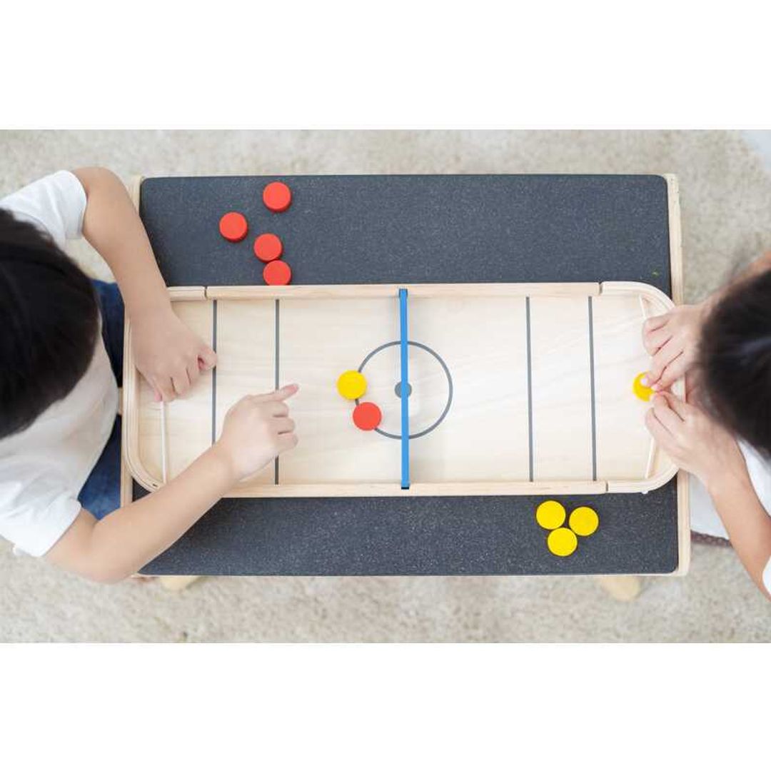 Children playing Shuffleboard-Game by Plan Toys