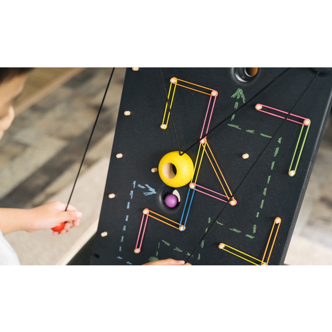 Kids Playing with A PlanToys Wall Ball Game 