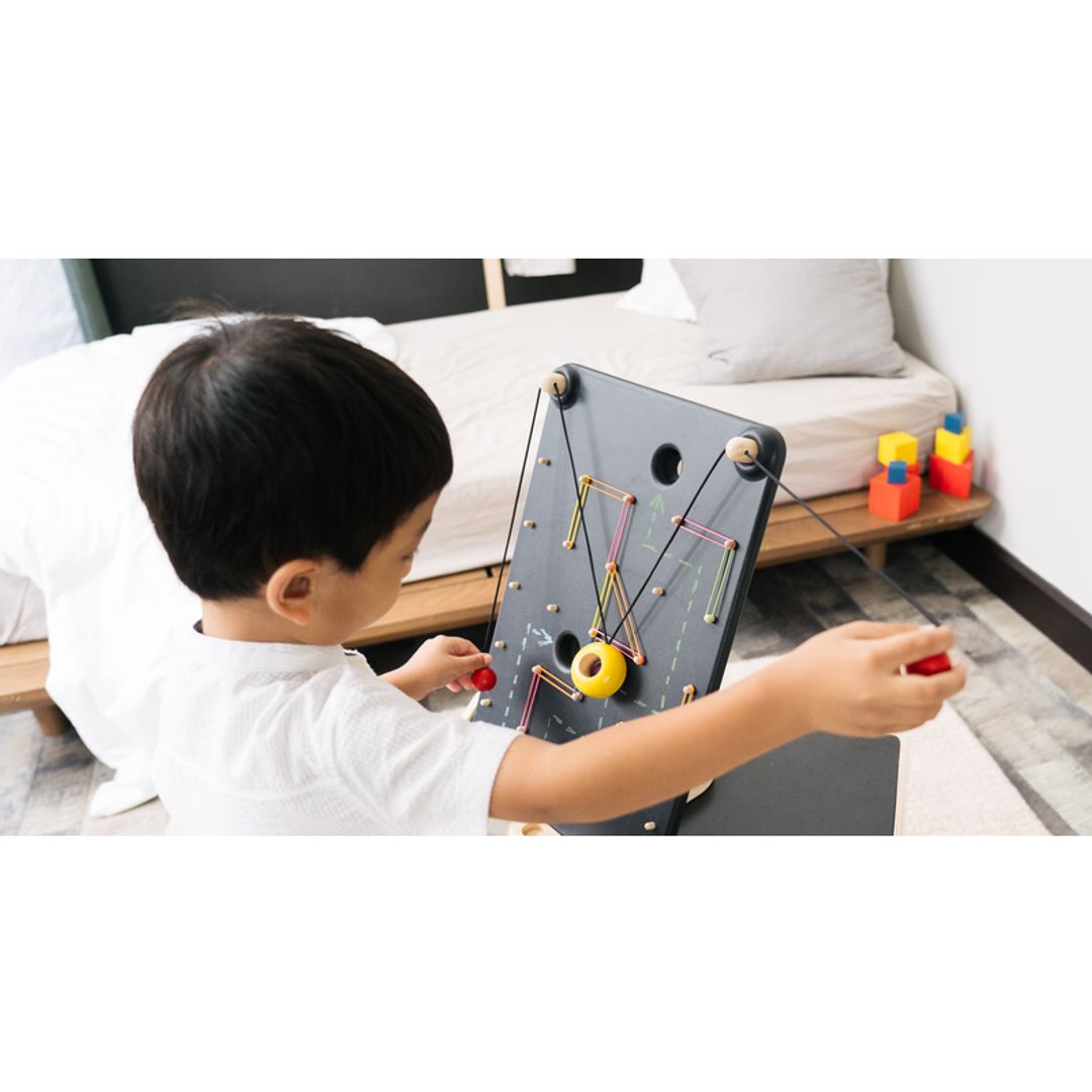 Kids Playing with A PlanToys Wall Ball Game