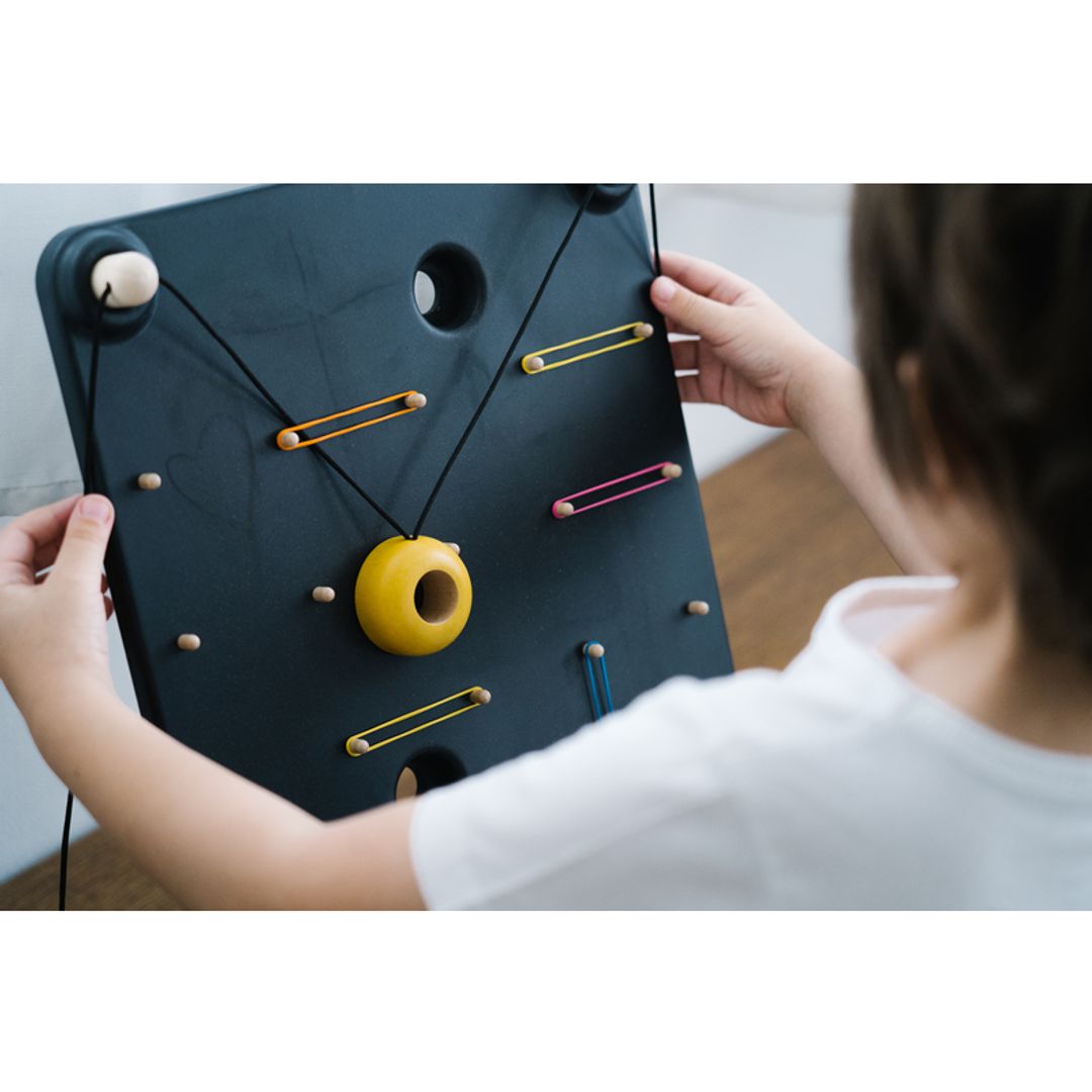 Kids Playing with A PlanToys Wall Ball Game