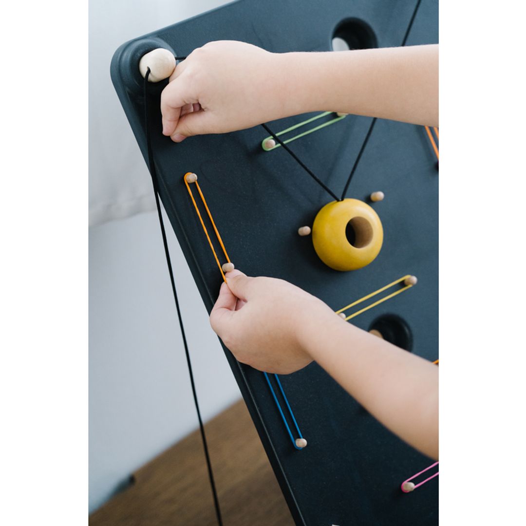 Kids Playing with A PlanToys Wall Ball Game