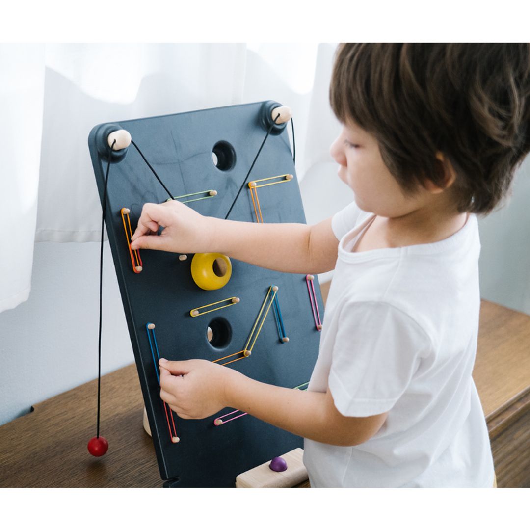 Kids Playing with A PlanToys Wall Ball Game