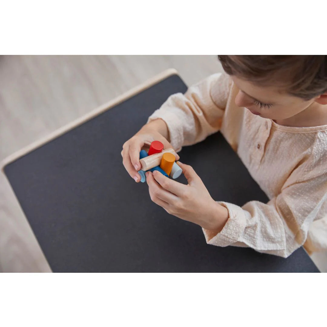 Child playing with PlanMini Log Puzzle