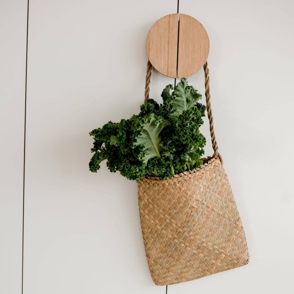 palm leaf handbag filled with kale