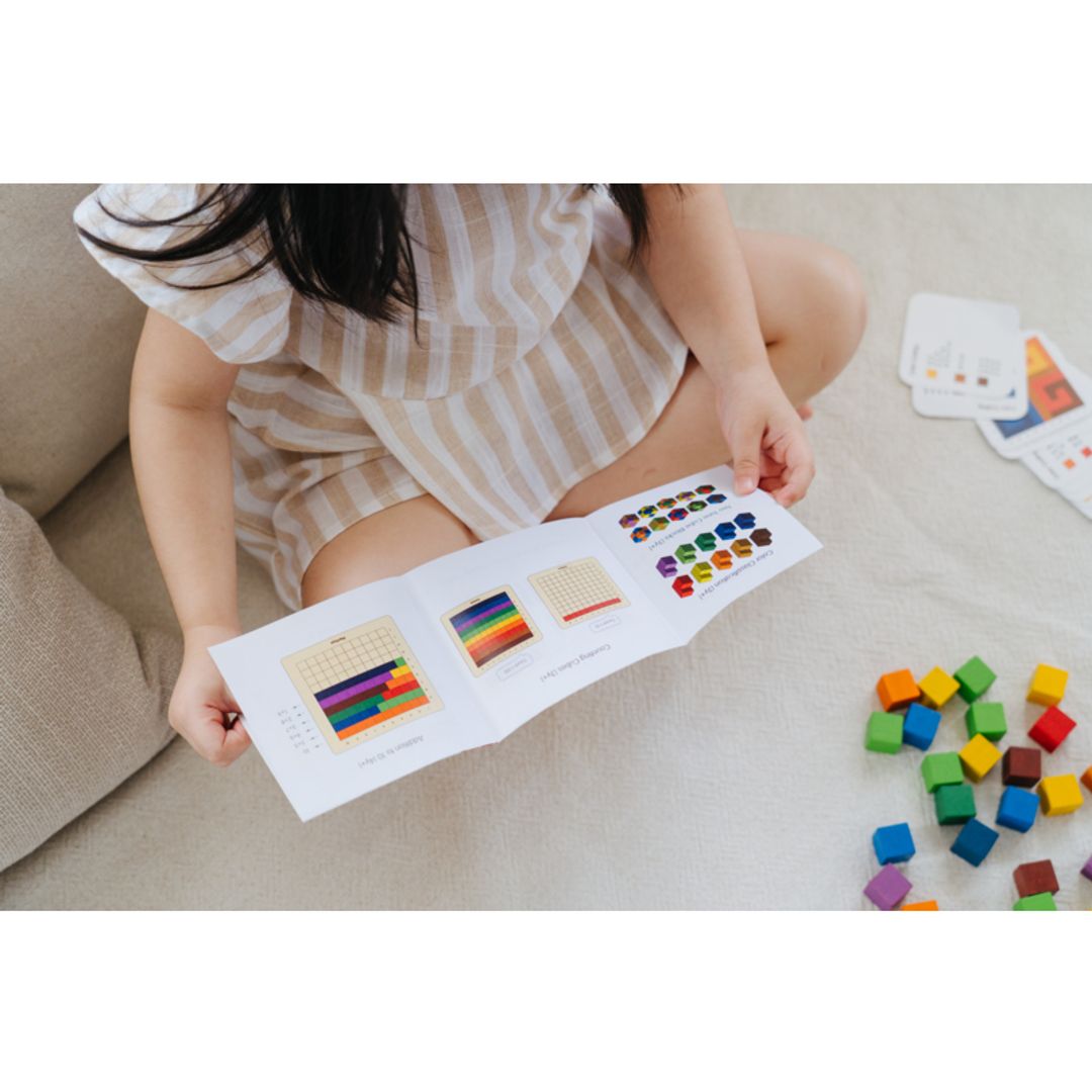 Child checking out the instructions for the 100 Counting Cubes - Unit Plus