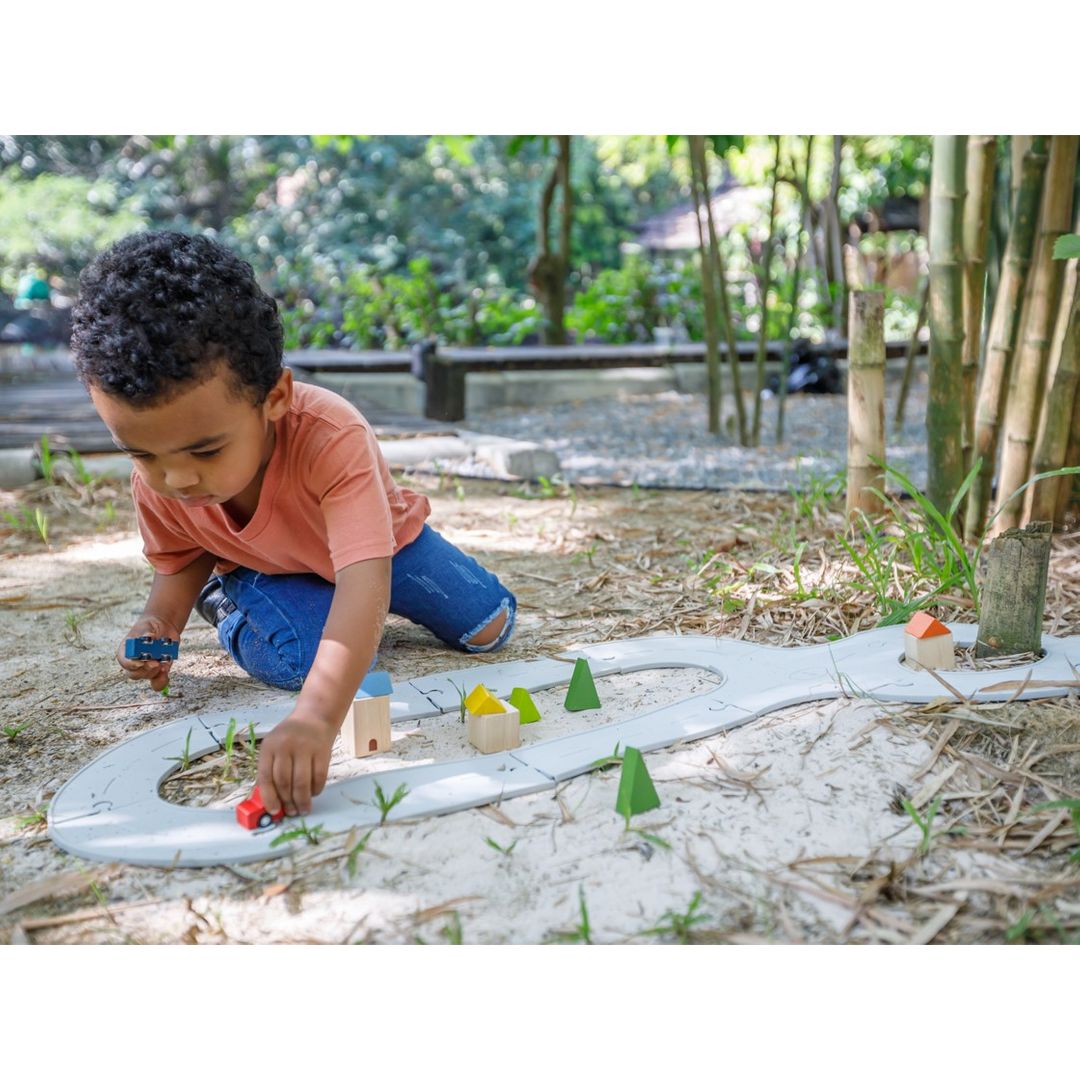 Child Playing with Rubber Road & Rail Set - Medium by Plan Toys