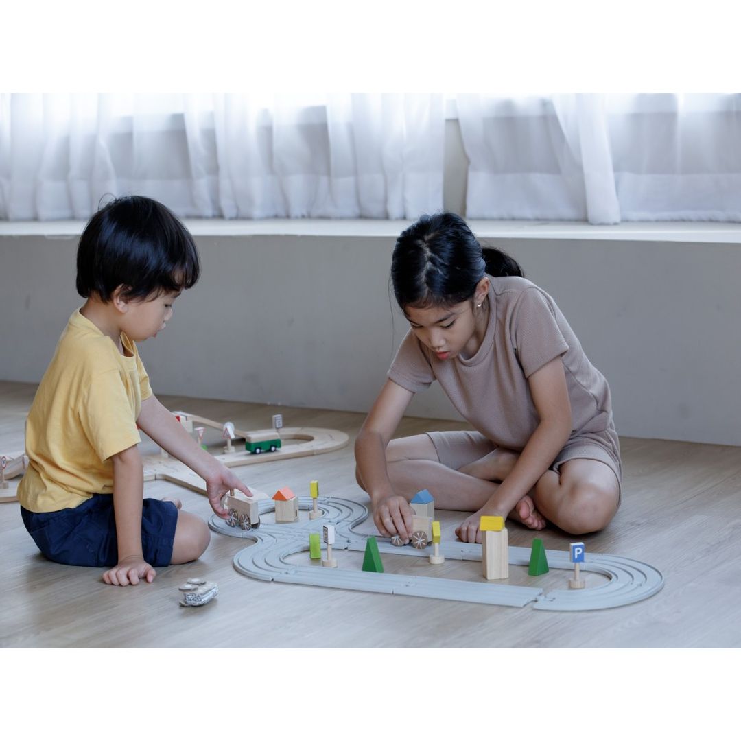 Child Playing with Rubber Road & Rail Set - Medium by Plan Toys