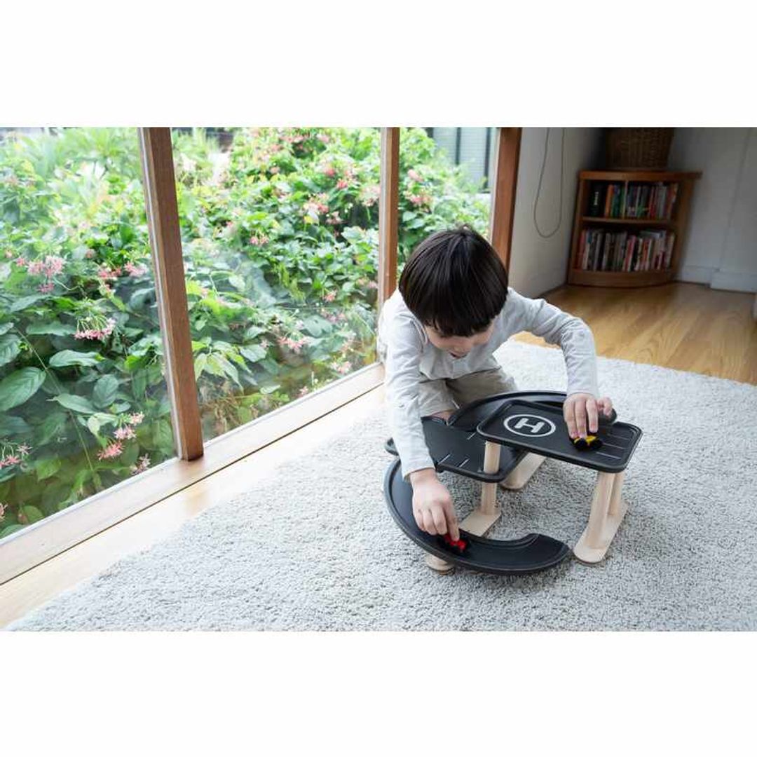 Child Play with Race N Play Parking Garage by Plan Toys