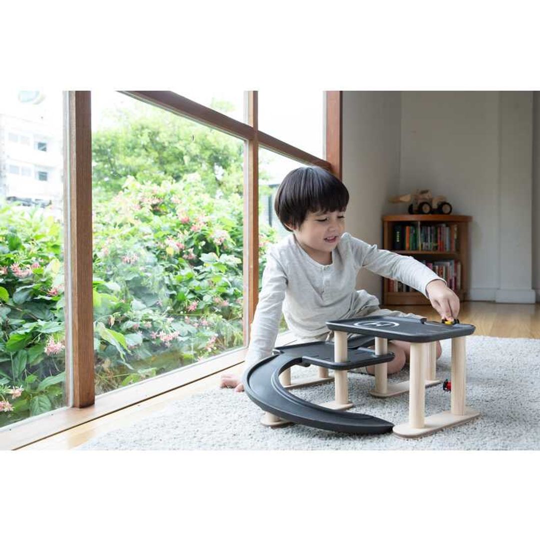 Child Play with Race N Play Parking Garage by Plan Toys