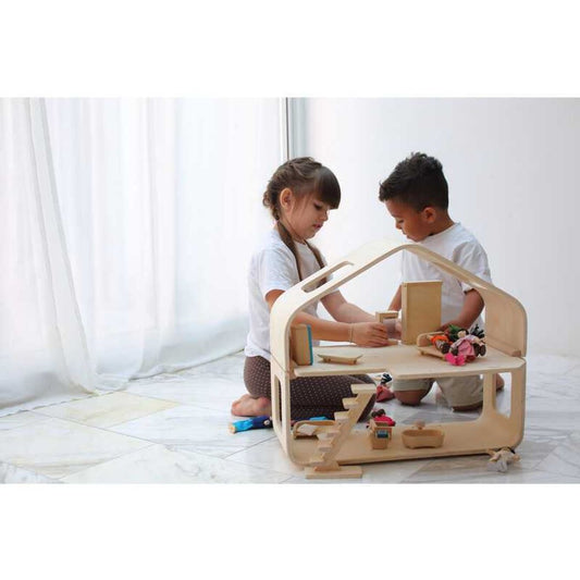 Kids Playing with a Contemporary Dollhouse by Plan Toys
