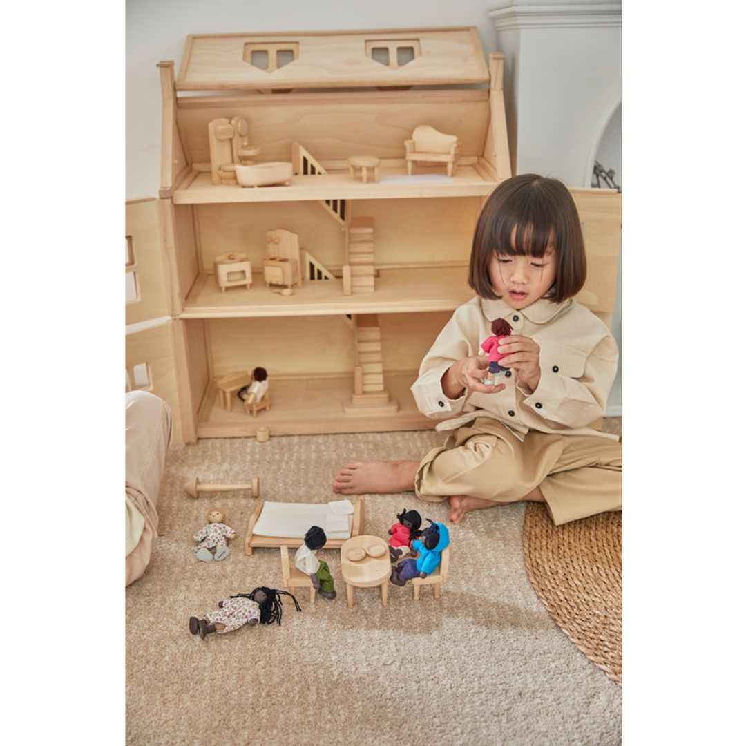 Child playing with PlanToys Victorian Furniture and Doll HouseSet 
