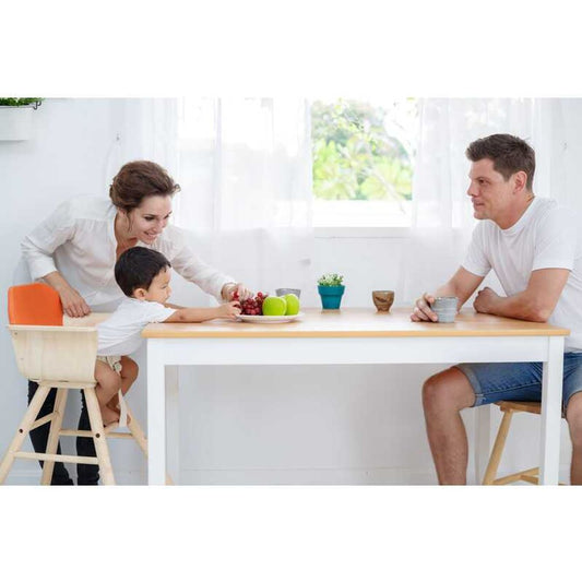 family at a table with a toddler using the High Chair - Orange