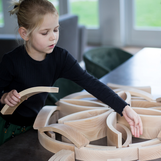 Child playing Abel Building Blocks on a table
