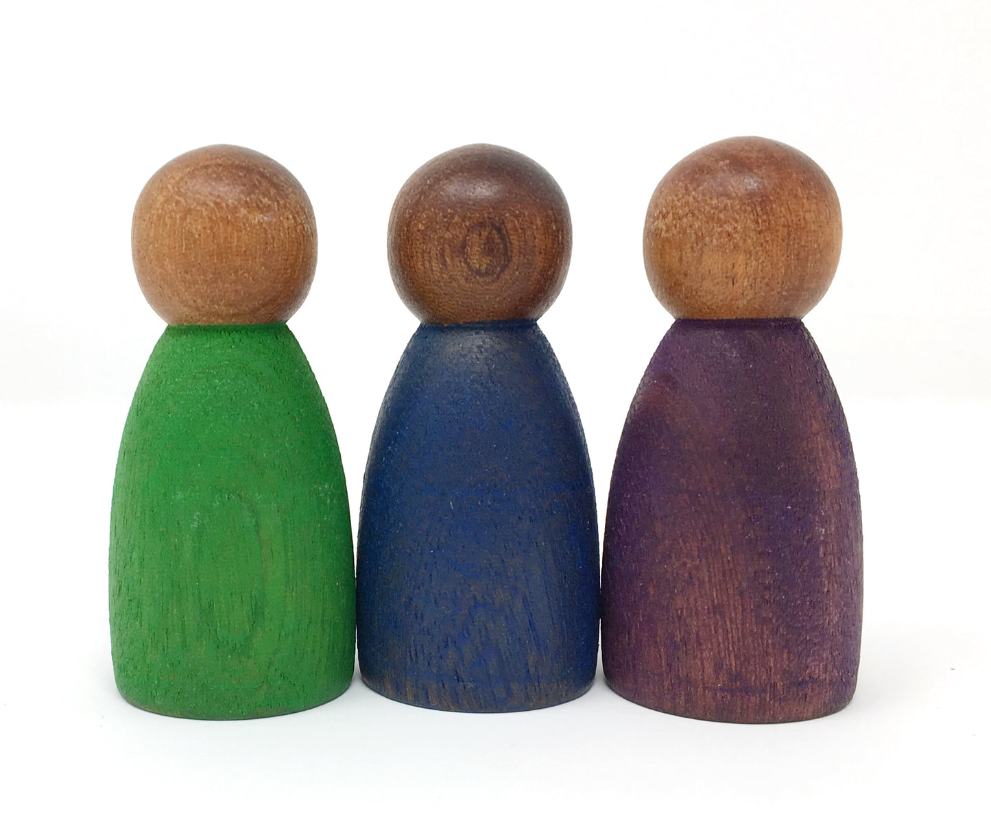 Three wooden peg people, one painted green, one blue, and one purple, from left to right