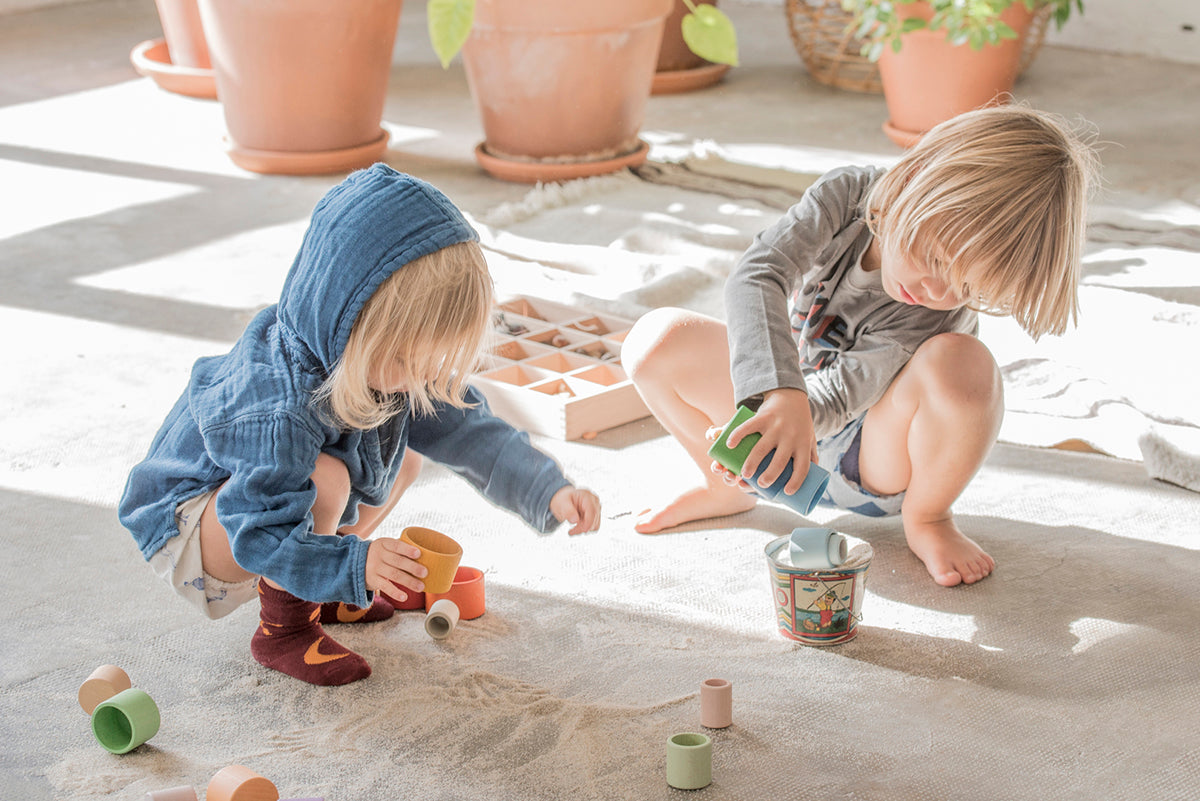 Children playing with nesting bowls