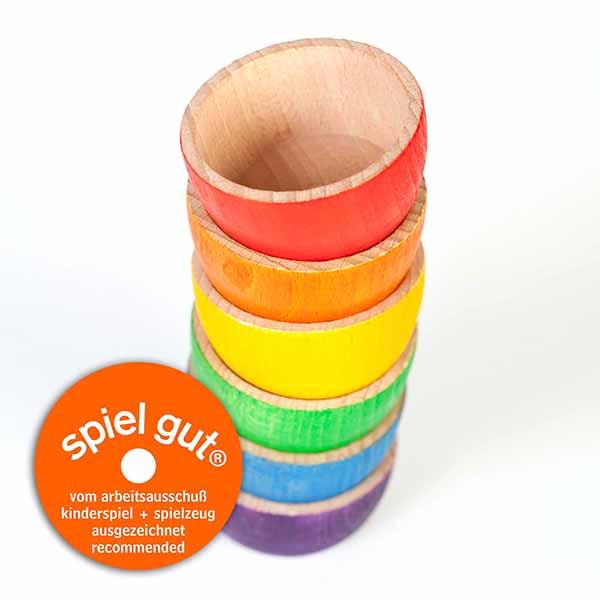 A set of six rainbow wooden bowls, stacked on top of each other in the rainbow colors order from top to bottom