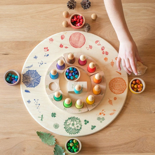 Seasonal platform with perpetual calendar, leaves, pinecones, and beads