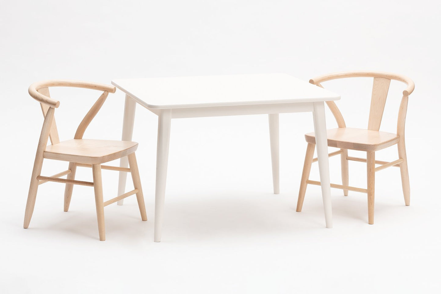 White crescent table by Milton and Goose with natural crescent chair set