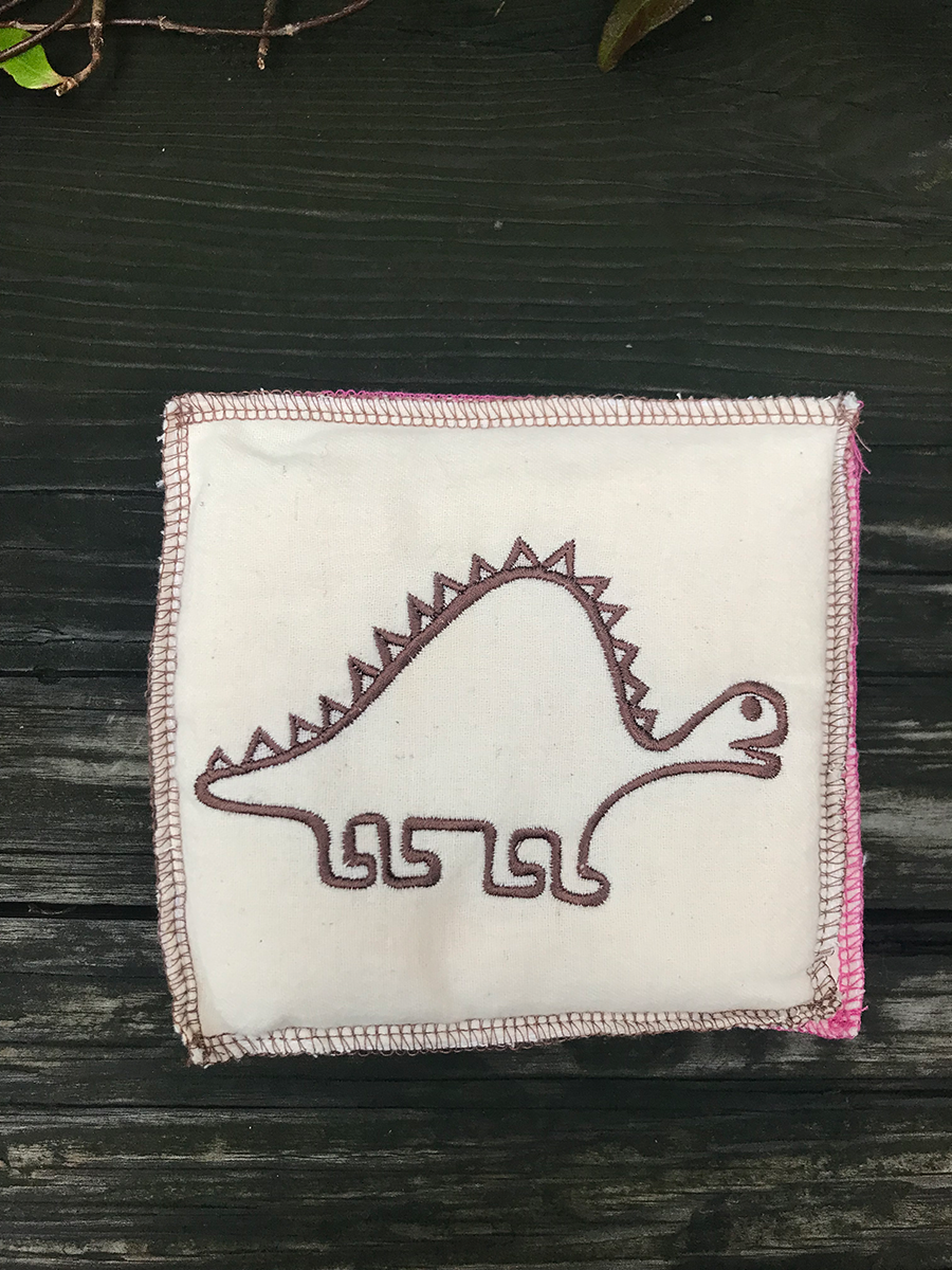 small dinosaur embroidered pillow