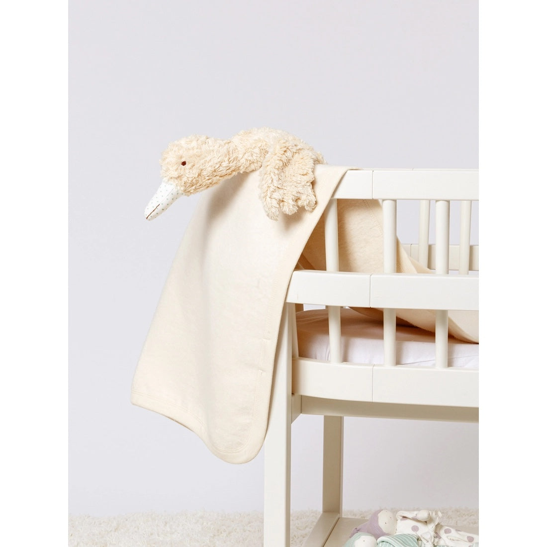Abigail Goose Sherpa Toy in a crib